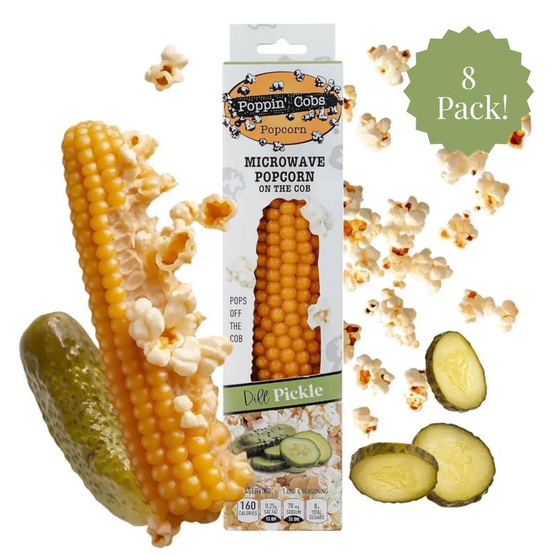 Poppin' Cobs microwave popcorn on the cob with pickles and popcorn kernels on a white background