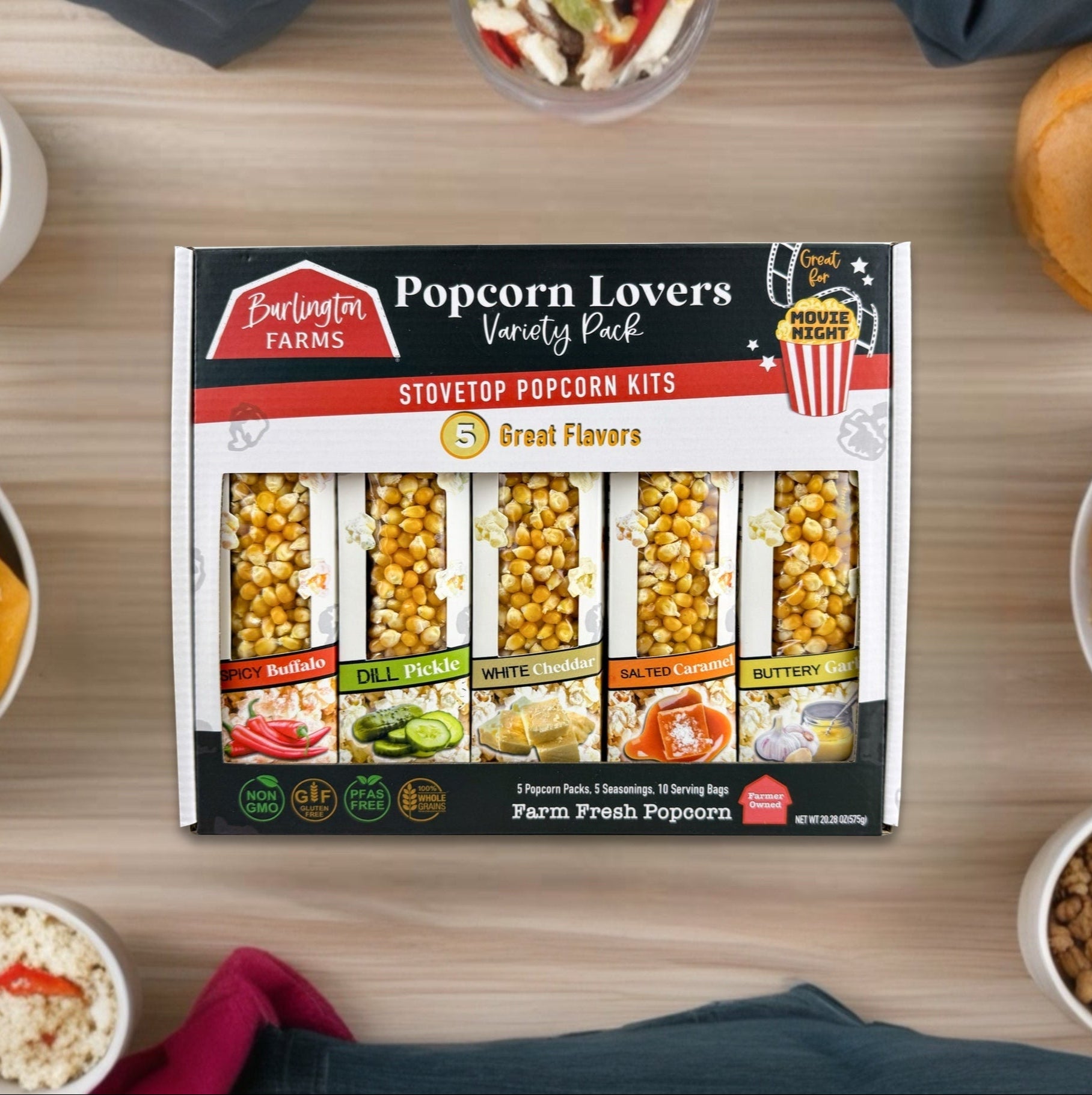 Burlington Farms Popcorn Lovers' Variety Pack on a table with popcorn and snacks.