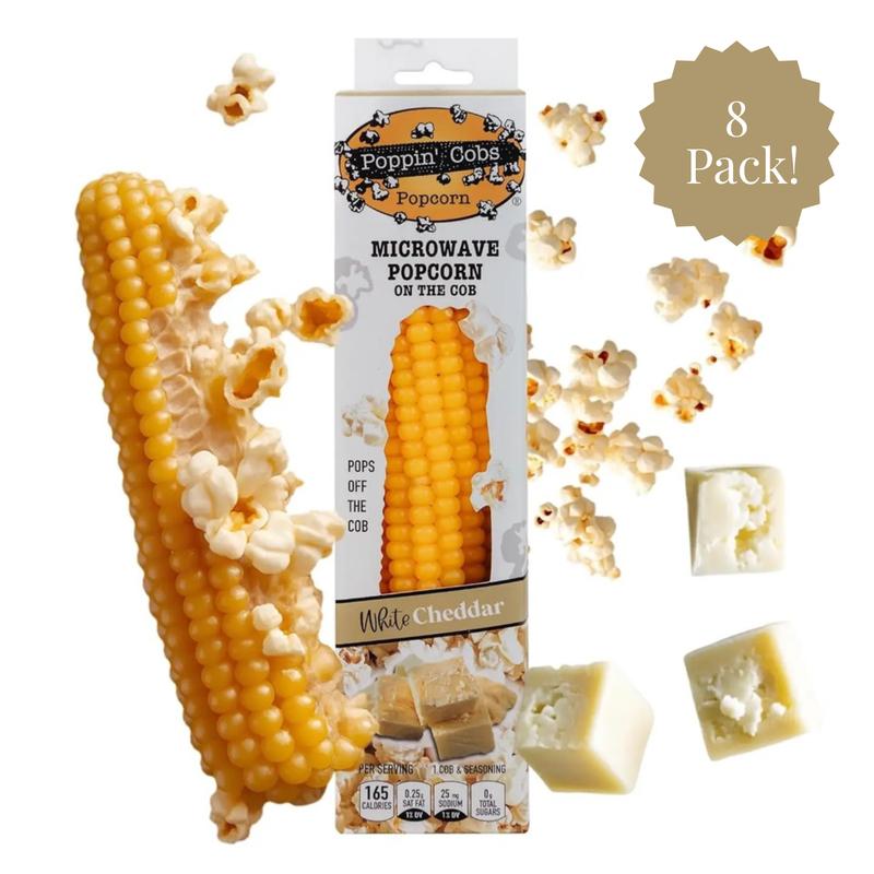 Poppin' Corn microwave popcorn on the cob with packaging and white cheddar cheese cubes.
